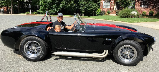 Aric Almirola and son Alex pose in 1965 Shelby 427 Cobra CSX 6086 gifted by Bill and Lori DenBeste